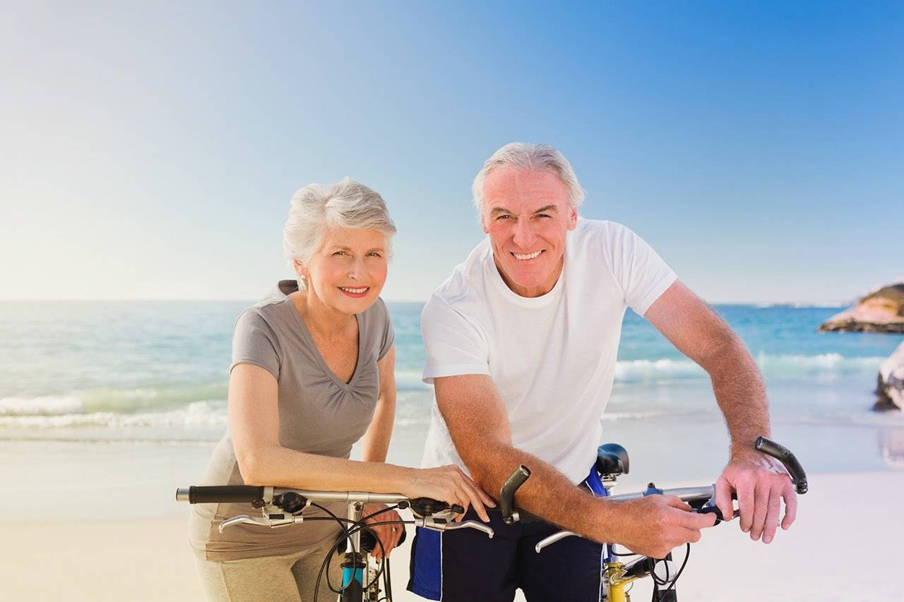 older man and woman on beach advertising eye care