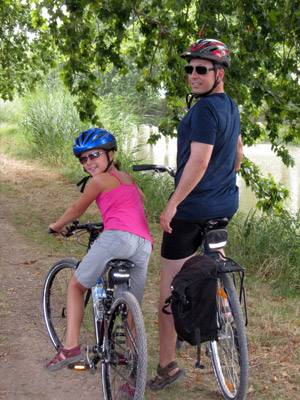 dad riding bike with daughter